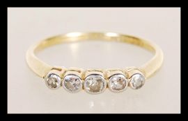 An 18ct stamped and platinum five stone diamond ring having five bevell set diamonds. Weighs 2.4