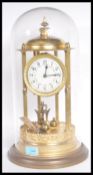 A large 19th Century Victorian glass domed anniversary clock raised on gilt brass circular base with