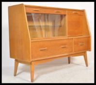 A vintage retro 20th Century E Gomme G-Plan oak cocktail cabinet sideboard credenza unit raised on