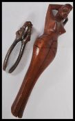 Two pairs of vintage nut crackers to include a pair of wooden ones modelled as a naked lady and