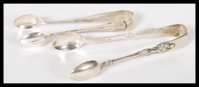 Two pairs of silver hallmarked sugar tongs, one pair with apostle in relief, London assay, dating to