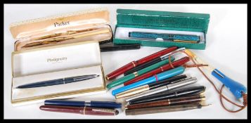 A collection of vintage 20th Century ink fountain pens to include Sheaffer, Parker, Waterman,