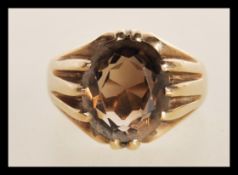 A hallmarked 9ct gold and smoky quartz ladies dress ring, weight 5.7g.