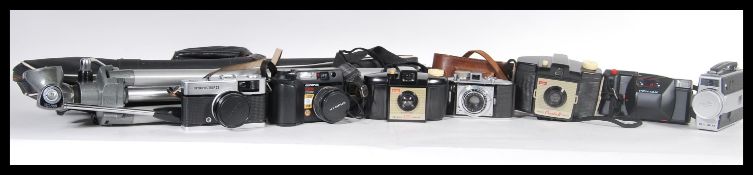 A collection of vintage film cameras to include a Kodak brownie 127 camera, a Olympus trip 35, an