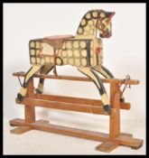A mid 20th Century childs rocking horse, the rocking horse intricately carved throughout and