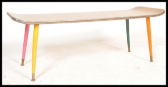 A vintage retro 20th Century teak coffee table of surfboard rectangular shape raised on tapering