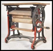 A vintage early 20th century Industrial Pioneer metamorphic mangle in pine and cast iron, the cast
