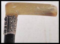 A 19th Century Victorian hallmarked silver collared walking stick cane having a tapering ebonised
