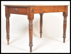 A 19th Century Victorian stripped pine kitchen / dining table enclosing a frieze drawer, the plank