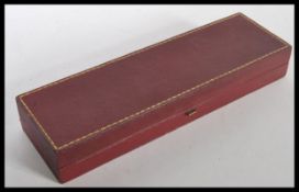 A vintage C & A Giuliano jewellery box having a red leatherette finish with gilt detailing, and a