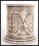 A hallmarked silver 925 brush pot of cylindrical form having scrolled decoration with relief leaf