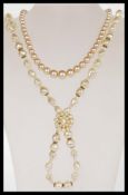 A vintage faux pearl graduated bead necklace having a platinum washed clasp complete in original box