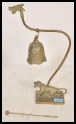 A 20th Century Chinese brass tiger and dragon bell gong raised on a figurine of a tiger with