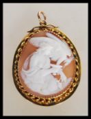 A 9ct gold hallmarked ladies shell cameo pendant. The central cameo depicting maiden and vulture