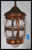 An early 20th Century hand blown and copper porch lantern complete with hanging chain and ceiling