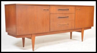 A vintage retro 20th Century teak wood Danish influence sideboard credenza having a central bank