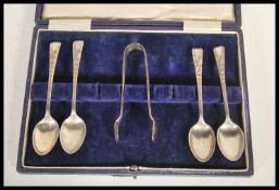 A set of four early 20th Century silver hallmarked Joseph Rogers & Sons teaspoons and a set of sugar