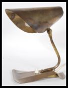A vintage retro 20th Century Art Deco brass desk table lamp having shaped neck with adjustable
