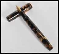 A vintage 20th Century Mentmore autoflow lever fill fountain pen having a 14k gold nib with brown