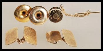 A 20th Century gentleman's lot consisting of a pair of stamped 9ct gold cufflinks, two stamped 9ct