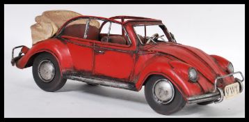 A 20th Century retro tinplate model Volkswagen Beetle, having a convertible canvas roof and