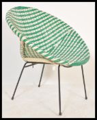 A vintage retro 20th Century wicker satellite chair raised on tubular legs and frame with green