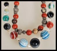 A 19th Century Victorian hand knotted Scottish banded agate bead necklace having clear glass faceted