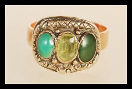 A 19th Century Victorian yellow metal gold ring set with differing three green stone cabochons