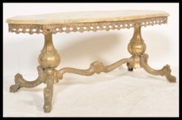 A 20th Century large brass and marble coffee table raised on a gilt brass base with scrolled