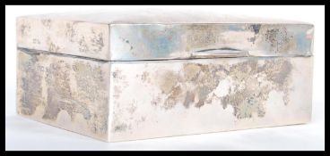 An early 20th Century hallmarked silver cigarette box by Deakin and Francis. The hinged lid