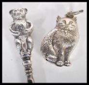 A hallmarked silver lace hook having a handle in the form of a bear along with a silver plated