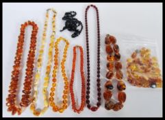 A collection of faux amber necklaces to include a cherry amber bakelite type bead necklace,