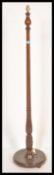 A vintage 20th Century mahogany standard lamp, raised on a circular base with turned upright column.