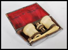 A pair of 19th Century Victorian ivory mounted opera glasses having folding handle. Complete in