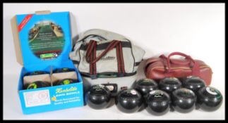 Three set of vintage 20th Century lawn bowls to include a boxes Kenselite example and two sets in