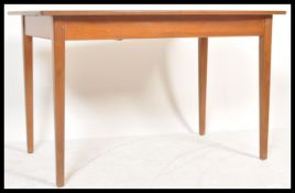 A vintage retro 20th Century teak Danish influence dining table. The extending dining table with