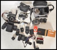 A collection of vintage 20th Century 35mm cameras and lenses to include a Pentax Super F1, Ashai