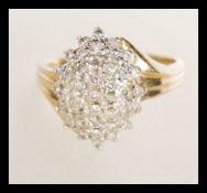 A 9k stamped 9ct gold and diamond ring having pave set cluster of white stones. Weighs 4.2 grams