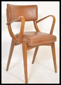A vintage retro 20th Century Ben Chairs armchair raised on shaped angular legs with leather / faux