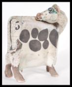 A vintage retro 20th Century Raku studio art pottery figurine of a cow of square form having bold no