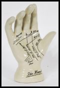 A vintage style Phrenology type Palmistry ceramic hand having instructions to palm. Measures 19 cm