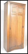 A mid century oak single / sentry box wardrobe in the manner of Jaycee / Old Charm having carved
