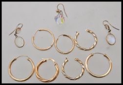 A group of 9ct gold earrings to include a opalescent moonstone set pair of drop earrings, pairs of