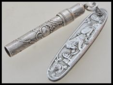 A continental silver 800 stamped propelling pencil having armorial scroll decoration along with a