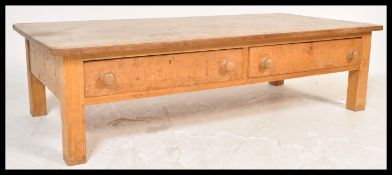 A large 20th Century scrubbed pine farmhouse coffee table, fitted with long frieze drawers with