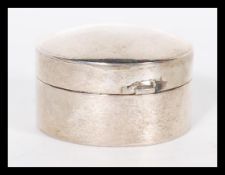 A 20th Century hallmarked silver pill box or counter case of cylindrical form having hinged circular