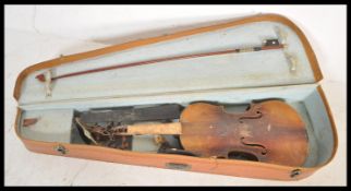 A vintage early 20th Century 3/4 size violin musical instrument having a two piece maple back with