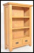 A contemporary chunk oak furniture land style upright wine cabinet bookcase. The top with
