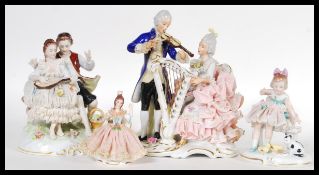 A selection of early 20th Century German figurines to include a Unterweissbach figure group
