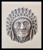 A stamped 925 silver ring in the form of a Native American wearing a feathered head dress. Weight